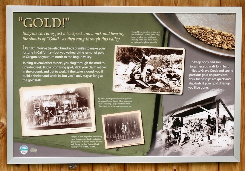 An informative sign with the title "Gold!" and multiple old photos collaged throughout. The first line reads "Imagine carrying just a backpack and a pick and hearing the shouts of "Gold!" as they rang through this valley."