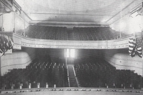 Vintage black and white photo of an 1800s Opera House in Grants Pass, two floors are seen with hundreds of seats.