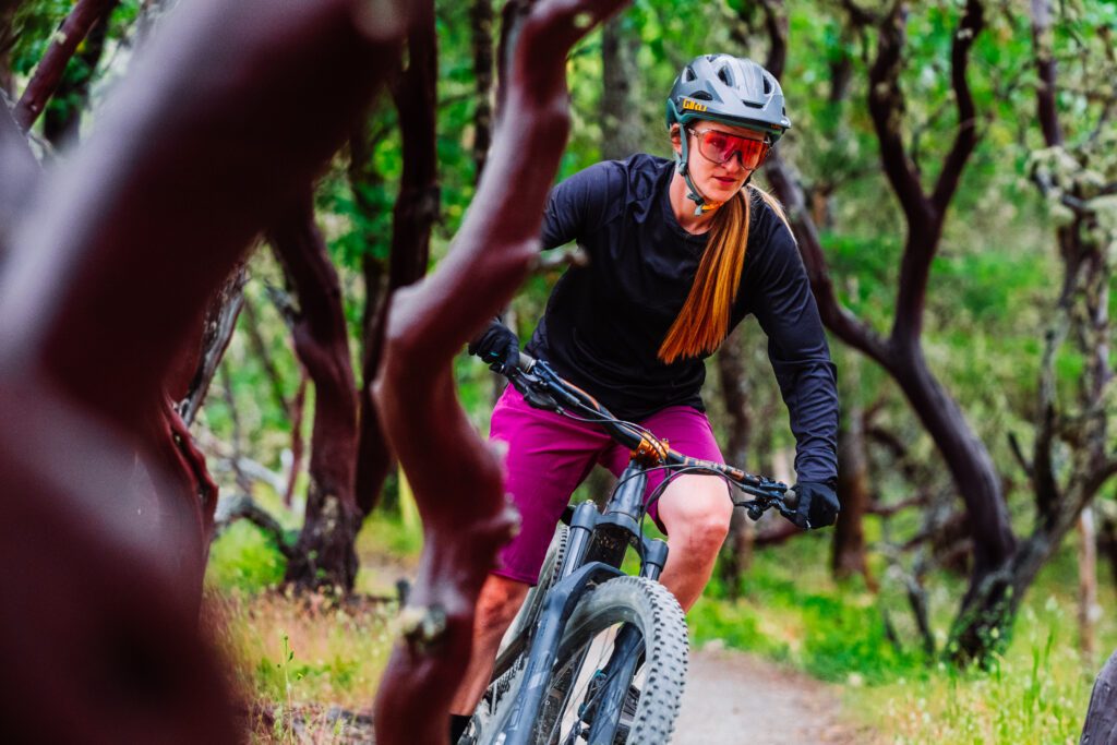 Mountain biker weaving between wavy trees.