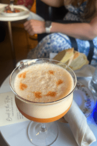 Partake Wine fine dining garnished orange cocktail in goblet