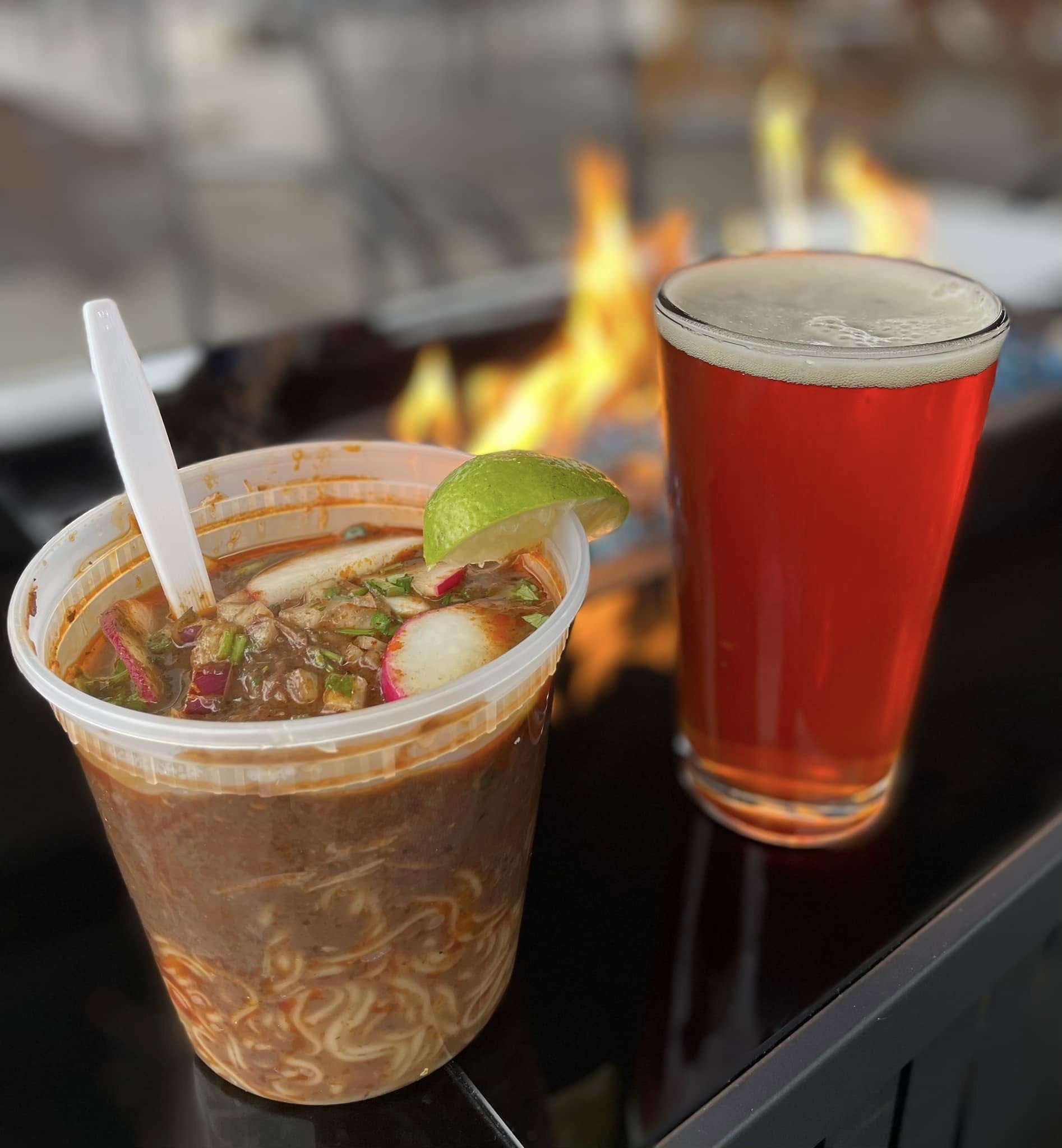 Area 61 beer by the fire with noodles to go